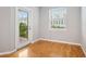 Bright bedroom with wood floors and private balcony access at 1810 E Palm Ave # 1205, Tampa, FL 33605