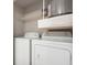 Laundry closet with washer, dryer, and overhead shelving at 1810 E Palm Ave # 1205, Tampa, FL 33605