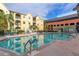Community pool with surrounding patio and building view at 1810 E Palm Ave # 1205, Tampa, FL 33605