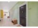 Condo hallway with light walls, tiled floor, and a black door to unit 1205 at 1810 E Palm Ave # 1205, Tampa, FL 33605