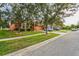 House on a tree-lined street with a spacious driveway at 612 Marion Hill Ln, Ruskin, FL 33570