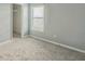Cozy bedroom with neutral walls, carpet, and a window with blinds at 612 Marion Hill Ln, Ruskin, FL 33570