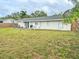 Large grassy backyard with patio and wooden fence at 3310 W 63Rd W St, Bradenton, FL 34209