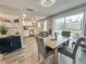 Light-filled dining area with wood table and gray chairs, adjacent to kitchen at 3310 W 63Rd W St, Bradenton, FL 34209