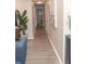 Long hallway with wood-look floors and neutral wall paint at 3310 W 63Rd W St, Bradenton, FL 34209