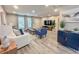 Bright living room with comfy seating, large TV, and wood-look floors at 3310 W 63Rd W St, Bradenton, FL 34209