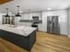 Modern kitchen with large island and white cabinets at 736 Mac Crillus Rd, Largo, FL 33770