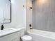 Modern bathroom featuring tiled shower/tub combo with black fixtures and white countertops at 101 Tompkins St, Port Charlotte, FL 33954