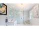 Modern bathroom with a soaking tub, glass shower, and marble tile at 2041 Beach Dr Se, St Petersburg, FL 33705