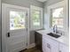 Updated kitchen with white cabinets, quartz countertops, and exterior access at 2041 Beach Dr Se, St Petersburg, FL 33705