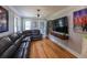 Spacious living room with hardwood floors, grey walls, and comfortable seating, perfect for relaxation and entertainment at 2041 Beach Dr Se, St Petersburg, FL 33705
