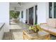 Inviting covered porch featuring tiled flooring, ceiling fans, and outdoor seating at 2041 Beach Dr Se, St Petersburg, FL 33705