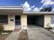 Tan house exterior with open garage door, showing the interior at 4945 Docner St, New Port Richey, FL 34652