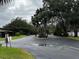 Community entrance with gated access and lush landscaping at 4622 Blossom Blvd # 4622, Zephyrhills, FL 33542