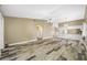 Open living room showcasing wood-look tile floors and views into the kitchen at 1125 Somerset S Cir, Dunedin, FL 34698