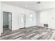 Spacious living room with wood-look floors and an interior door at 1543 Mackinaw St, North Port, FL 34286