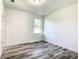 Bright bedroom with wood-look floors and a window with natural light at 1543 Mackinaw St, North Port, FL 34286