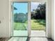 Sliding glass door opens to a backyard with grassy area at 1543 Mackinaw St, North Port, FL 34286