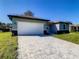 House exterior with white garage door and paved driveway at 1543 Mackinaw St, North Port, FL 34286