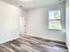 Simple bedroom with wood-look floors and access to a bathroom at 1543 Mackinaw St, North Port, FL 34286