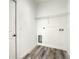 Bright laundry room with vinyl flooring and overhead shelving at 1543 Mackinaw St, North Port, FL 34286