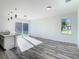 Bright living room featuring wood-look floors and sliding glass doors at 1543 Mackinaw St, North Port, FL 34286