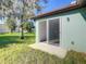 Home exterior with a sliding glass door opening onto a grassy area at 1543 Mackinaw St, North Port, FL 34286