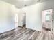 Spacious bedroom with wood-look floors and en-suite bathroom at 1543 Mackinaw St, North Port, FL 34286