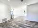 Open floor plan with kitchen and living area, showcasing wood-look floors at 1543 Mackinaw St, North Port, FL 34286