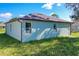 Rear view of the house, showcasing teal siding and brown roof at 1543 Mackinaw St, North Port, FL 34286
