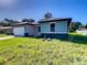 House exterior features teal siding, a brown roof, and a stone accent at 1543 Mackinaw St, North Port, FL 34286