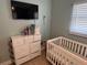 bedroom with crib, dresser, and plenty of storage at 5732 Beneva Rd, Sarasota, FL 34233