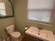 Clean bathroom with toilet, sink, and mirror at 5732 Beneva Rd, Sarasota, FL 34233