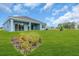 The back of the house shows the beautiful backyard with lush green grass at 2515 Wise River Lane, Zephyrhills, FL 33539