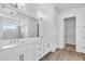 Elegant bathroom featuring double sinks, a large mirror, and a glass-enclosed shower at 2515 Wise River Lane, Zephyrhills, FL 33539