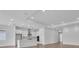 Modern kitchen featuring white cabinets, a large island, stainless steel appliances and hardwood floors at 2515 Wise River Lane, Zephyrhills, FL 33539