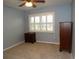 Bright bedroom featuring a window with shutters and neutral colored walls at 903 Pinellas Bayway S # 302, Tierra Verde, FL 33715