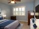 Virtually staged bedroom with a dresser, nightstand, and large window at 903 Pinellas Bayway S # 302, Tierra Verde, FL 33715