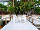 Private dock with a small table and chairs, overlooking the water at 903 Pinellas Bayway S # 302, Tierra Verde, FL 33715