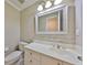 Bathroom featuring bright lighting, a large mirror, and a modern vanity with storage at 903 Pinellas Bayway S # 302, Tierra Verde, FL 33715