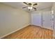 Cozy bedroom featuring wood floors, a ceiling fan, closet, and neutral colored walls at 903 Pinellas Bayway S # 302, Tierra Verde, FL 33715