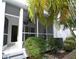 Exterior view of the property highlighting the lanai and tropical foliage at 903 Pinellas Bayway S # 302, Tierra Verde, FL 33715