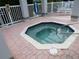 Inviting octagon-shaped hot tub with blue trim and a handrail for easy access to the soothing waters at 903 Pinellas Bayway S # 302, Tierra Verde, FL 33715