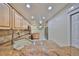 Well-lit kitchen with granite countertops, stainless steel appliances, a tile backsplash, and lots of wooden cabinetry at 903 Pinellas Bayway S # 302, Tierra Verde, FL 33715