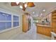 Sun-filled kitchen with stainless steel appliances, custom cabinets, granite countertops, and open access to backyard at 903 Pinellas Bayway S # 302, Tierra Verde, FL 33715