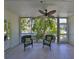 Enclosed lanai with fan, tiled flooring and relaxing seating area at 903 Pinellas Bayway S # 302, Tierra Verde, FL 33715