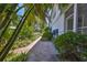 Well-maintained brick pathway surrounded by lush tropical foliage and landscaping at 903 Pinellas Bayway S # 302, Tierra Verde, FL 33715