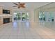 Spacious living room features a tiled floor, fireplace, and sliding glass doors to a private outdoor area at 903 Pinellas Bayway S # 302, Tierra Verde, FL 33715