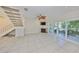 Bright living room features a fireplace, tile flooring, staircase, and access to an outdoor balcony at 903 Pinellas Bayway S # 302, Tierra Verde, FL 33715