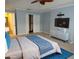 Serene main bedroom with a king bed, closet, and mounted TV at 903 Pinellas Bayway S # 302, Tierra Verde, FL 33715